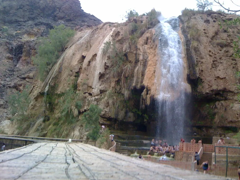 Hot waterfall falling over travertine rock at Maʿin Hot Springs, Jordan
