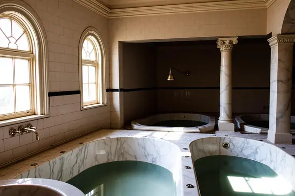 Marble tubs and arched windows in a historic Hot Springs bathhouse