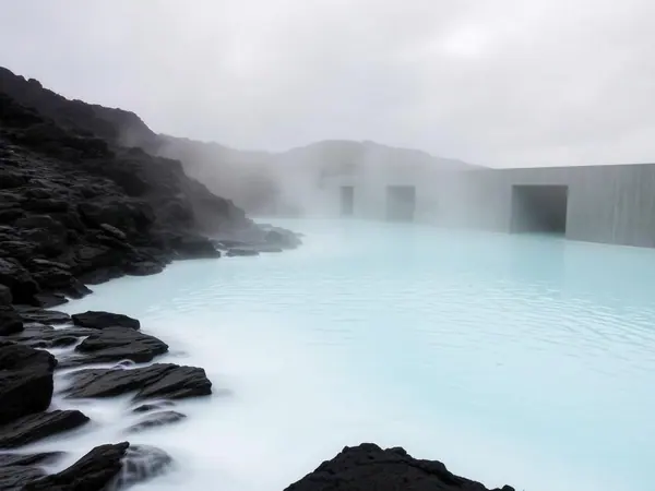 Pale geothermal water in a black lava field at the Blue Lagoon