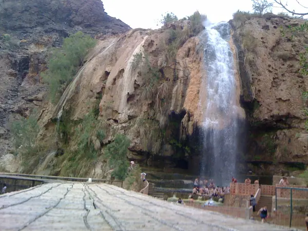 Hot waterfall falling over travertine rock at Maʿin Hot Springs, Jordan