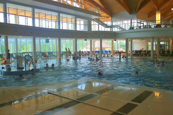 Indoor geothermal pool hall with glass walls at Terma Bukovina