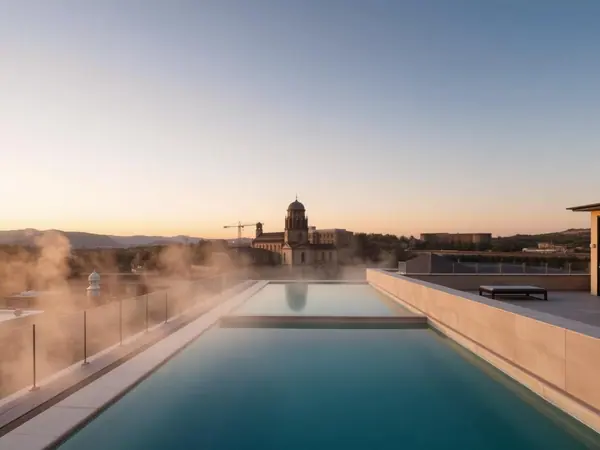Steam rising from the rooftop thermal pool above the rooftops of Bath
