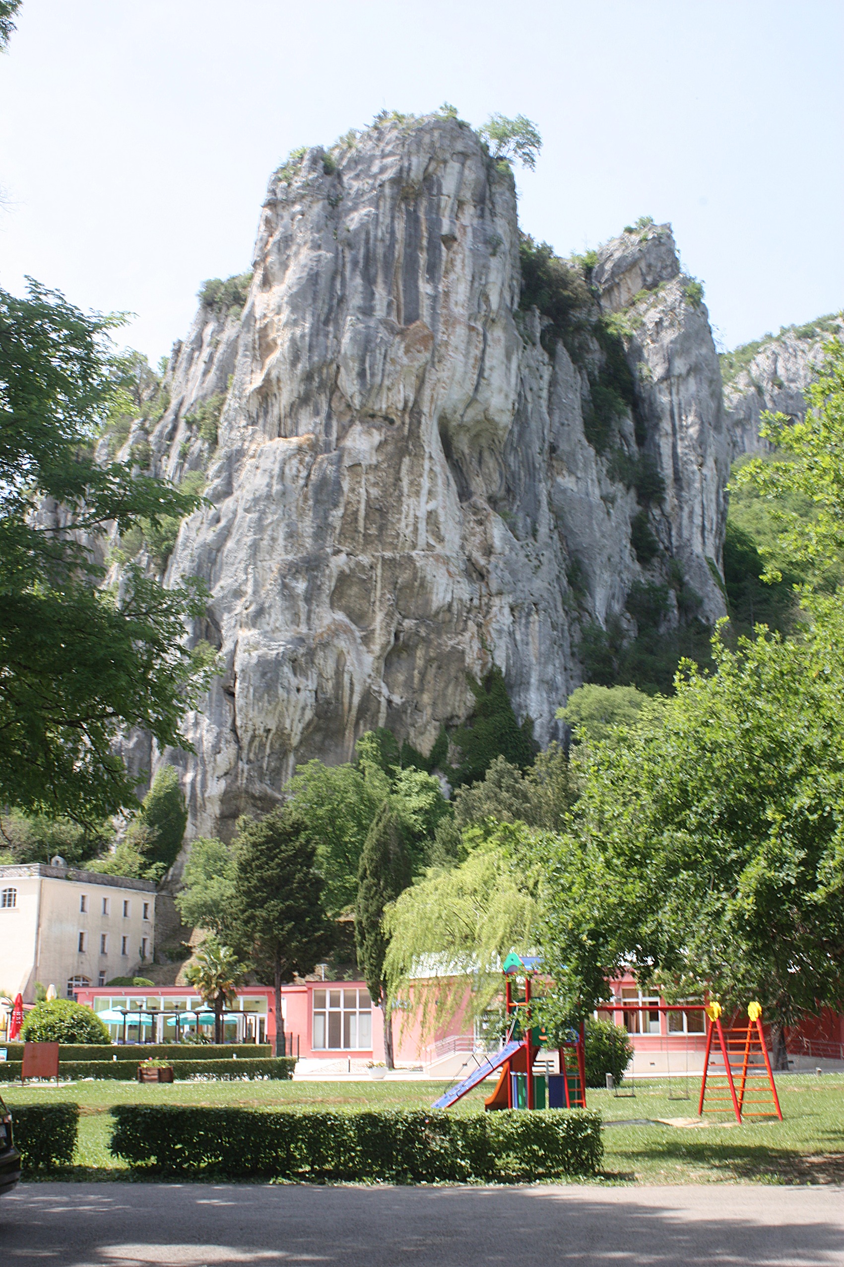 The spa buildings of Istarske Toplice beneath a limestone cliff in Istria